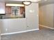 An open-concept living area with a view to the kitchen area and light-colored walls at 3420 W Danbury Dr # C130, Phoenix, AZ 85053