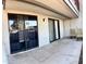 This patio includes sliding glass doors, outdoor seating, and a white entrance door at 3420 W Danbury Dr # C130, Phoenix, AZ 85053
