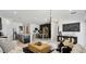 Open-concept living room with modern decor, seamlessly connecting to the kitchen and dining areas at 35545 N Breezy Ln, San Tan Valley, AZ 85140