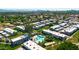Aerial view showcases a residential neighborhood with a pool, mature trees and grass at 3820 N 30Th St, Phoenix, AZ 85016