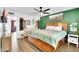 Cozy bedroom with decorative wood bed frame, hardwood floors, and a bright window at 3820 N 30Th St, Phoenix, AZ 85016