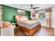 Cozy bedroom with decorative wood bed frame, hardwood floors, and a bright window at 3820 N 30Th St, Phoenix, AZ 85016