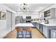 Modern kitchen featuring stainless steel appliances, gray cabinets, and a kitchen island with seating at 3820 N 30Th St, Phoenix, AZ 85016
