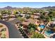 Picturesque aerial view highlighting a backyard oasis with a sparkling pool, lush landscaping, and mountain backdrop at 4055 N Recker Rd # 71, Mesa, AZ 85215