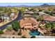Stunning aerial view of backyard pool and desert community with mountain views at 4055 N Recker Rd # 71, Mesa, AZ 85215