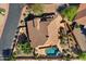 Overhead aerial view of a home with a tile roof, pool, well-kept landscaping, and a convenient outdoor storage shed at 4055 N Recker Rd # 71, Mesa, AZ 85215