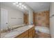 Elegant bathroom featuring double sinks, granite counters, a shower, and a soaking tub at 4055 N Recker Rd # 71, Mesa, AZ 85215