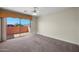 Bright bedroom featuring sliding glass doors to a private balcony, and neutral carpet at 4055 N Recker Rd # 71, Mesa, AZ 85215