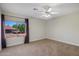 Neutral bedroom with ceiling fan and a large window providing natural light at 4055 N Recker Rd # 71, Mesa, AZ 85215