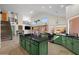 Open-concept kitchen featuring a large island, green cabinetry, granite countertops, and modern appliances at 4055 N Recker Rd # 71, Mesa, AZ 85215