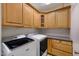 Well-equipped laundry room with modern washer and dryer, wooden cabinetry, and countertop space at 4055 N Recker Rd # 71, Mesa, AZ 85215