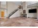 Open-concept living room showcases high ceilings, staircase, and a cozy fireplace at 4055 N Recker Rd # 71, Mesa, AZ 85215