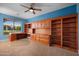 Office featuring a built in desk, cabinets, shelving and a ceiling fan at 4055 N Recker Rd # 71, Mesa, AZ 85215