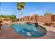 Gorgeous pool with waterfall feature surrounded by lush landscaping at 4055 N Recker Rd # 71, Mesa, AZ 85215