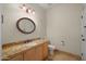 Elegant powder room featuring granite counters, ample vanity, and a decorative mirror at 4055 N Recker Rd # 71, Mesa, AZ 85215