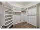 Spacious walk-in closet with built-in shelving and hanging rods for ample storage at 4055 N Recker Rd # 71, Mesa, AZ 85215