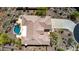 Aerial view of home with desert landscaping, swimming pool, patio, and a long driveway at 42145 N Fairgreen Ct, Anthem, AZ 85086