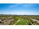 Scenic aerial view of a lush green golf course winding through a desert residential community at 42145 N Fairgreen Ct, Anthem, AZ 85086