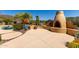 This back patio features a fireplace, desert landscaping, and ample space for entertaining guests at 42145 N Fairgreen Ct, Anthem, AZ 85086