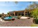 Beautiful backyard pool and patio is surrounded by lush desert landscaping at 42145 N Fairgreen Ct, Anthem, AZ 85086