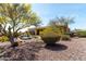 The backyard features desert landscaping and a beautiful pool, creating a relaxing and inviting outdoor space at 42145 N Fairgreen Ct, Anthem, AZ 85086