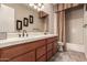 Bathroom featuring double sinks, vanity, large mirror, and tub/shower at 42145 N Fairgreen Ct, Anthem, AZ 85086