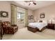 Bedroom featuring a large window, a ceiling fan, and neutral-toned decor at 42145 N Fairgreen Ct, Anthem, AZ 85086