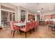 Elegant dining area flowing into the kitchen, featuring a large table, sleek chairs and natural lighting at 42145 N Fairgreen Ct, Anthem, AZ 85086