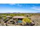 Luxury home featuring an outdoor living space with a pool, desert landscaping, and golf course views at 42145 N Fairgreen Ct, Anthem, AZ 85086