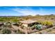 Aerial view of a luxurious desert home with a private pool and mountain views in a gated community at 42145 N Fairgreen Ct, Anthem, AZ 85086