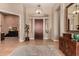 Elegant foyer features wood floors, decorative rug, and custom lighting creating a warm and inviting entrance at 42145 N Fairgreen Ct, Anthem, AZ 85086