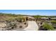 This beautiful home features desert landscaping, a large driveway, and a three-car garage at 42145 N Fairgreen Ct, Anthem, AZ 85086