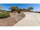 Front exterior of desert home with mature desert landscaping and a long driveway at 42145 N Fairgreen Ct, Anthem, AZ 85086