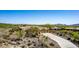 Desert home boasts mature landscaping, spacious driveway, and three-car garage at 42145 N Fairgreen Ct, Anthem, AZ 85086