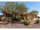 Well-maintained desert home with a three-car garage and mature trees and landscaping at 42145 N Fairgreen Ct, Anthem, AZ 85086
