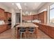 Gourmet kitchen with island seating, custom cabinetry, granite counters, and chef-grade stainless steel appliances at 42145 N Fairgreen Ct, Anthem, AZ 85086