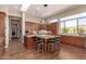 Open kitchen features custom cabinets, granite countertops, an island with seating, and stainless steel appliances at 42145 N Fairgreen Ct, Anthem, AZ 85086