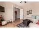 Living room featuring hardwood floors, a large sectional sofa, and doorway at 42145 N Fairgreen Ct, Anthem, AZ 85086