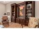 Cozy living room featuring a custom wooden built-in entertainment center and hardwood floors at 42145 N Fairgreen Ct, Anthem, AZ 85086