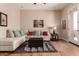 Living room featuring hardwood floors, a large sectional sofa, and neutral walls at 42145 N Fairgreen Ct, Anthem, AZ 85086