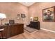 Well-lit office space with wood floors, rich colored walls, and custom wooden desk at 42145 N Fairgreen Ct, Anthem, AZ 85086