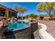 Beautiful blue swimming pool and landscaping in backyard make this home a relaxing retreat at 42145 N Fairgreen Ct, Anthem, AZ 85086