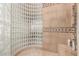 Walk-in shower featuring glass block wall and tile surround with shower bench at 42145 N Fairgreen Ct, Anthem, AZ 85086