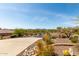 Street view featuring the home's concrete driveway, mature desert landscaping, and neighborhood surroundings at 42145 N Fairgreen Ct, Anthem, AZ 85086
