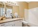 Bright bathroom featuring granite countertops, white cabinets, and a tub with shower at 4353 E Desert Wind Dr, Phoenix, AZ 85044