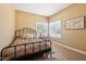 Cozy bedroom featuring wood-look flooring, a modern bed, and a bright window at 4353 E Desert Wind Dr, Phoenix, AZ 85044