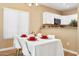 Dining area with seating for four, showcasing natural light and views into kitchen at 4353 E Desert Wind Dr, Phoenix, AZ 85044