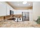 Bright kitchen with stainless steel appliances, granite countertops, a skylight, and ample cabinet space at 4353 E Desert Wind Dr, Phoenix, AZ 85044