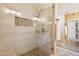 Modern shower with river rock floor and decorative tile inset in this bright, updated bathroom at 4353 E Desert Wind Dr, Phoenix, AZ 85044
