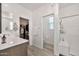 Bright bathroom with a glass-enclosed shower, vanity, and tile flooring at 4803 S Ferric --, Mesa, AZ 85212
